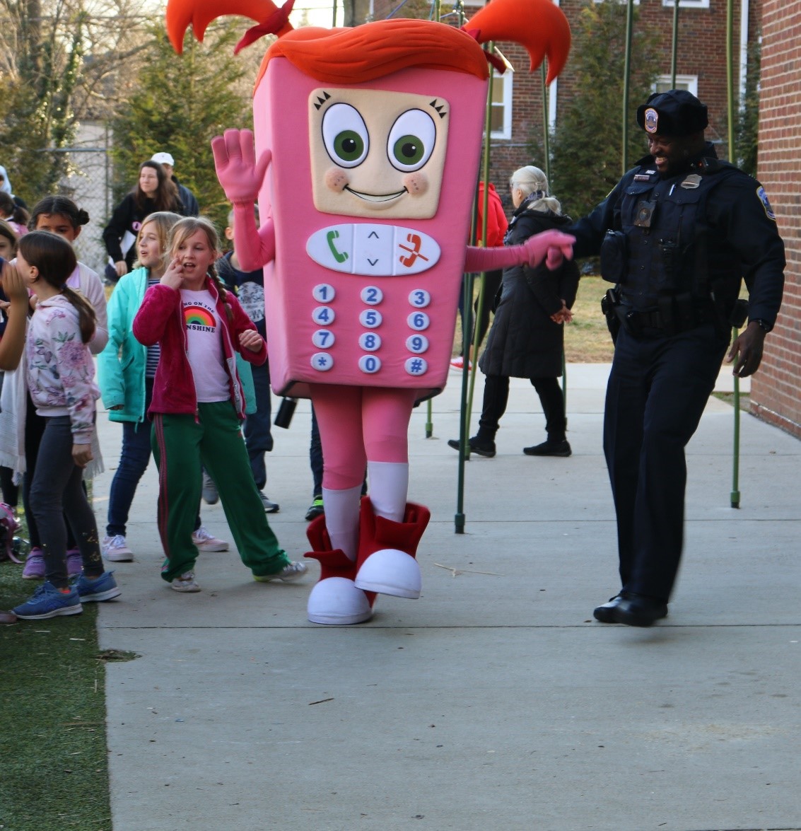 Cell Phone Sally, OUC's mascot, visits students with Officer Friendly.