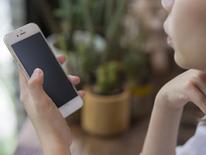 Text the Police photo of person using cell phone