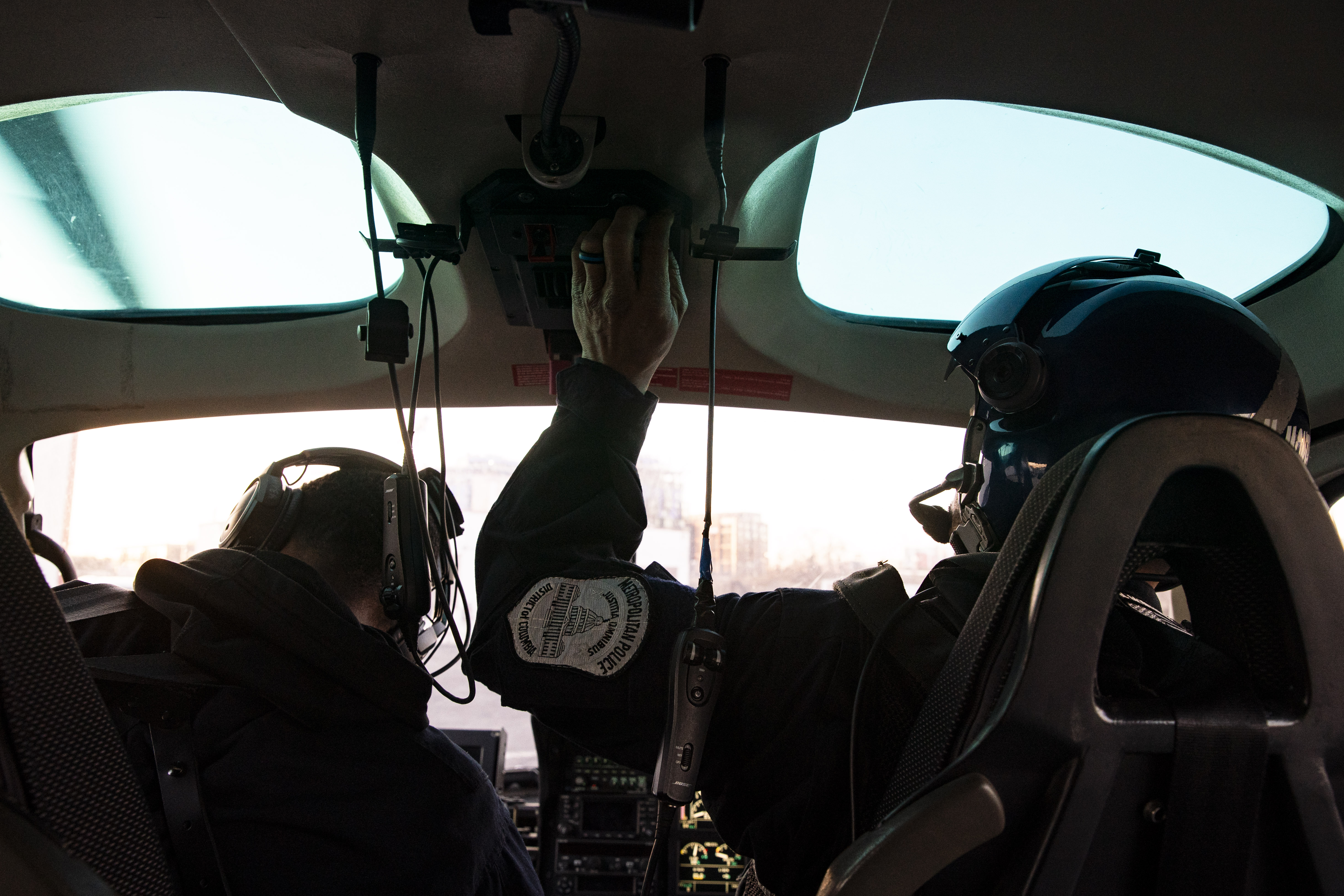 Two MPD members inside the cockpit of a helicopter